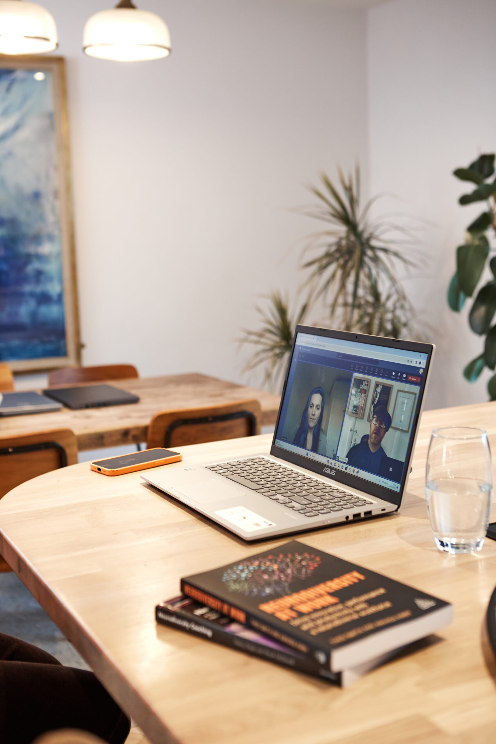 A business owner working with virtual support on a laptop